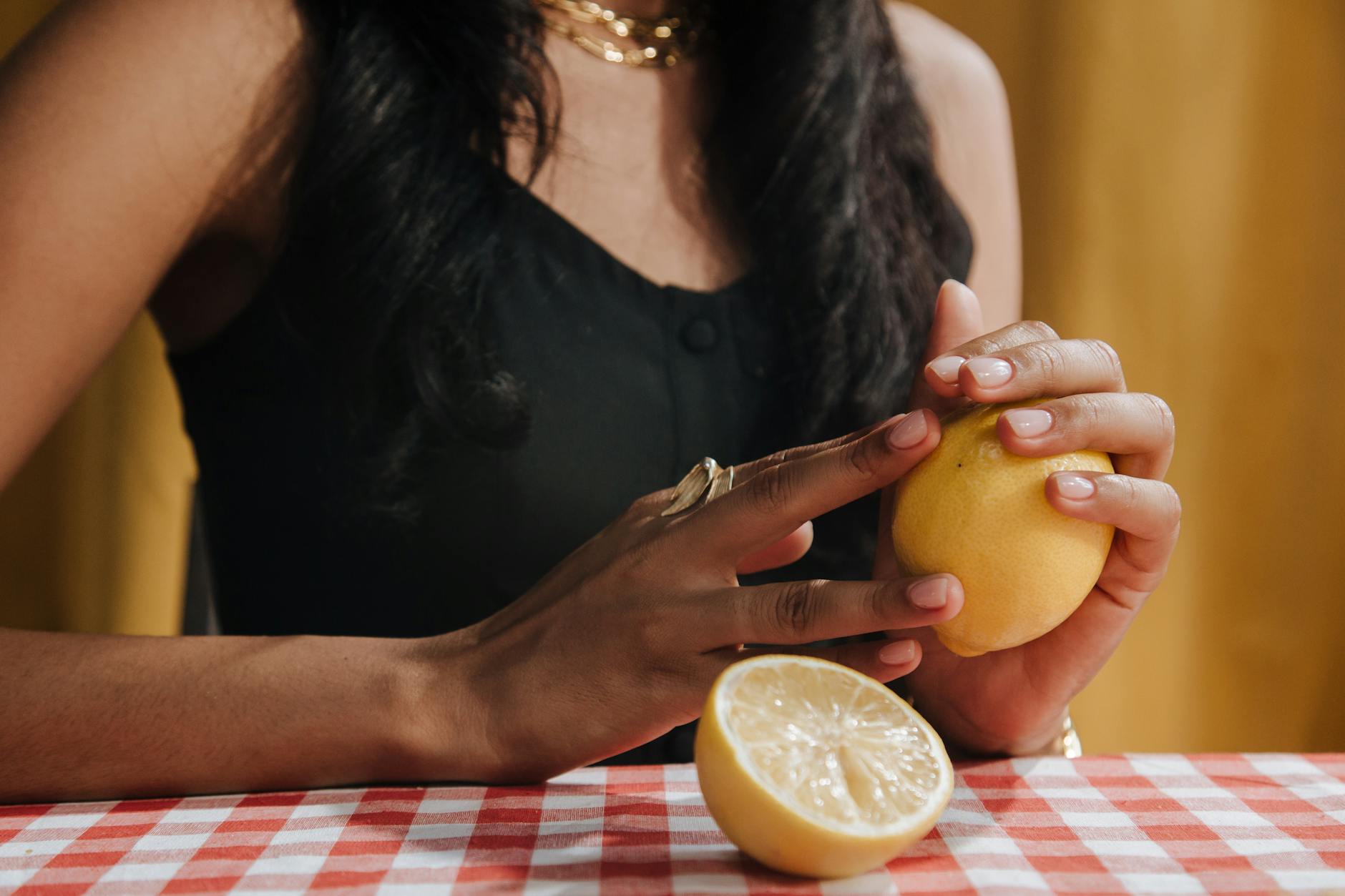 Close-up of hands holding a fresh lemon, symbolizing gentle touch and renewal