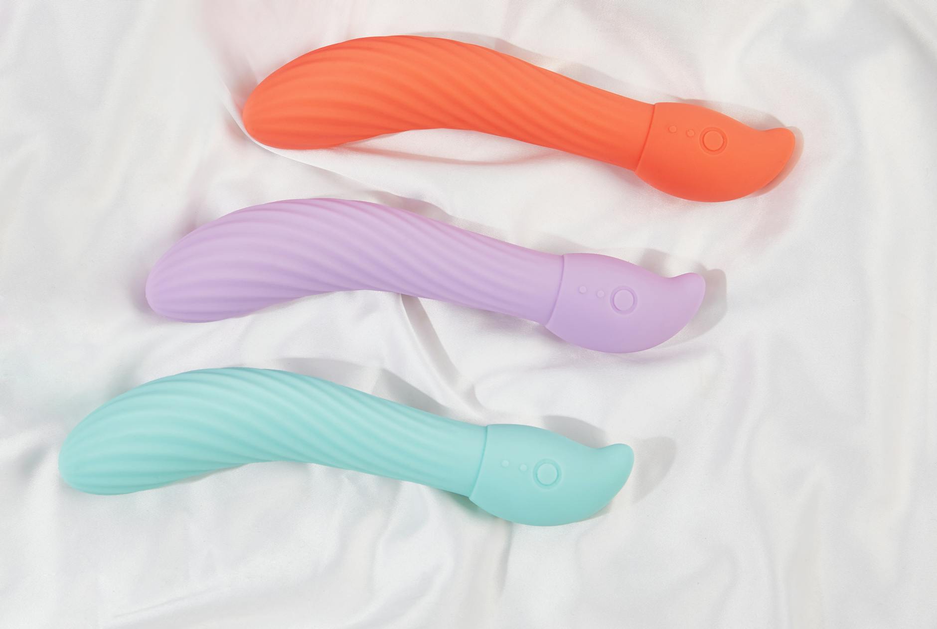 Close-up of adult toys including vibrators displayed together, representing sexual wellness and partnership.